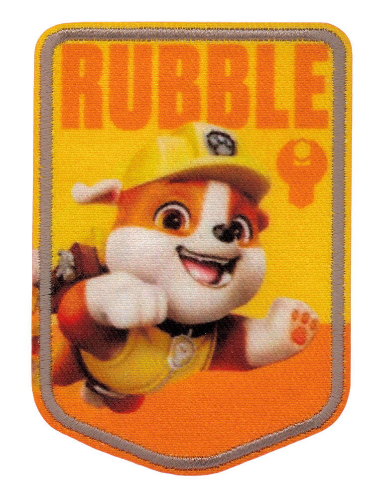 ”Paw Patrol-tygmärke med Rubble i gul bygghjälm mot gul och orange bakgrund och texten RUBBLE upptill.”